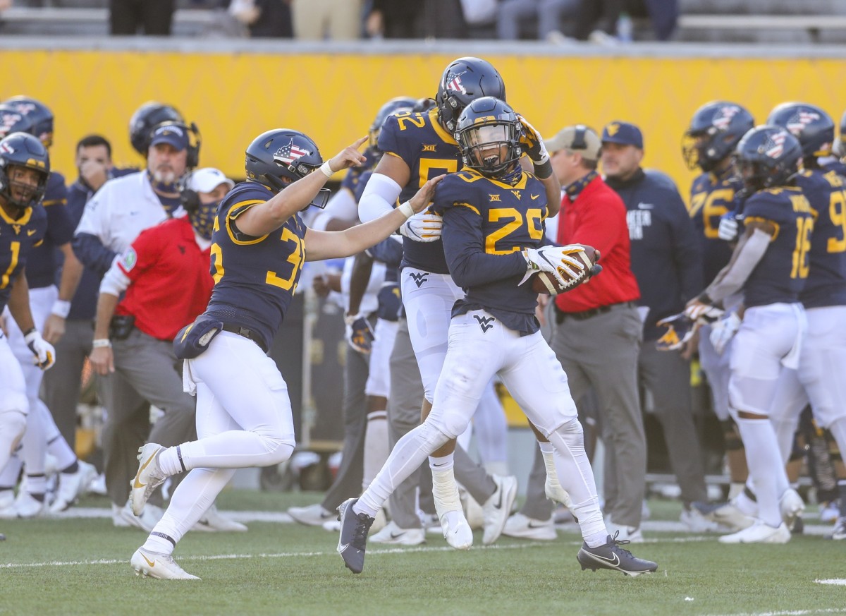 Nov 14, 2020; Morgantown, West Virginia, USA; West Virginia Mountaineers safety Sean Mahone (29) celebrates with teammates after recovering a fumble during the third quarter during the fourth quarter against the TCU Horned Frogs at Mountaineer Field at Milan Puskar Stadium.